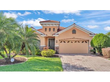 Charming single-story home featuring a tile roof, two-car garage, landscaped yard, and well-maintained lawn at 3978 Viamonte Ln, Lakeland, FL 33810