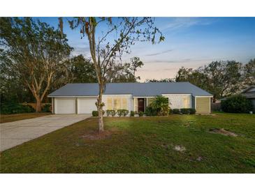 Charming single story home with metal roof and an attached two car garage in a scenic landscape at 4550 Old Colony Rd, Mulberry, FL 33860