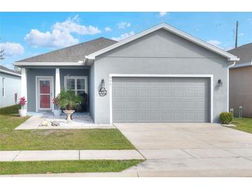 Charming single-story home with a well-manicured lawn and inviting curb appeal at 477 Kensington View Dr, Winter Haven, FL 33880