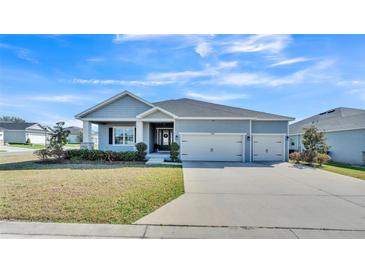 Charming single-story home with well-manicured lawn and a three-car garage, located in a Gathering-friendly neighborhood at 5806 Valentino Way, Lakeland, FL 33812