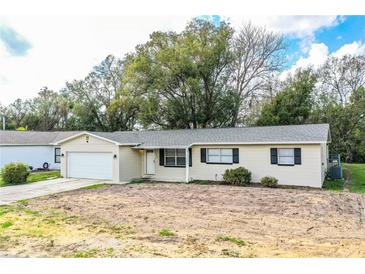 Charming single-story home with a well-manicured lawn and attached two-car garage at 1548 Churchill Ct, Lakeland, FL 33801