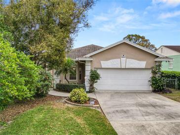 Charming single-story home featuring a stucco exterior, well-manicured lawn, and an attached two-car garage at 2616 Fairmount Ave, Lakeland, FL 33803