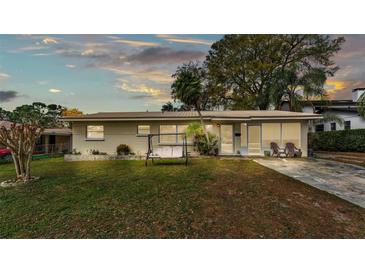 Charming single-story home with well-manicured lawn and inviting front porch swing at 3207 S Polk Ave, Lakeland, FL 33803