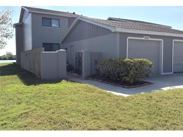 This meticulously landscaped two-story home features a private gated entrance and attached one-car garage at 3350 Kilmer Dr, Lakeland, FL 33803