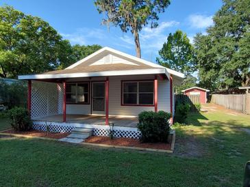 Charming home featuring a covered front porch, well-maintained lawn, and inviting curb appeal at 5515 3Rd Se St, Lakeland, FL 33812