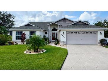 Charming single-story home featuring a well-manicured lawn and a welcoming two-car garage at 5982 Crane Dr, Lakeland, FL 33809