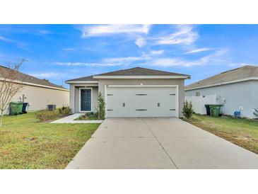 Charming single-story home featuring a two-car garage, lush lawn and well-maintained landscaping at 965 Eagle Rock Ter, Winter Haven, FL 33880