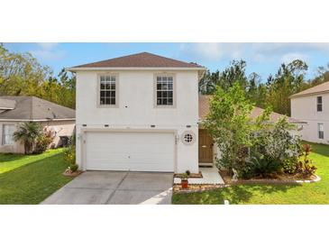 Charming two-story home featuring a two-car garage and a neatly landscaped front yard at 1526 Country Chase St, Lakeland, FL 33810