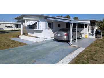Single story home with a covered parking area on a sunny day at 3030 Sun Way, Lakeland, FL 33801
