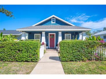 Charming blue house with a vibrant red door and well-maintained landscaping at 631 W Park St, Lakeland, FL 33803