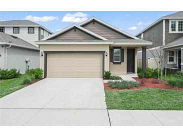 Charming single Gathering home boasting a well-manicured lawn and a two-car garage at 6533 Great Bear Dr, Lakeland, FL 33805