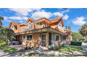 Charming townhome featuring a beautiful red tile roof and a cozy balcony, nestled within a lush, landscaped community at 8303 Waterview Way # 8303, Winter Haven, FL 33884