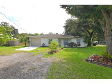 Charming single-story home with a well-maintained lawn and mature trees, creating a welcoming curb appeal at 1065 Jordan Rd, Lakeland, FL 33811