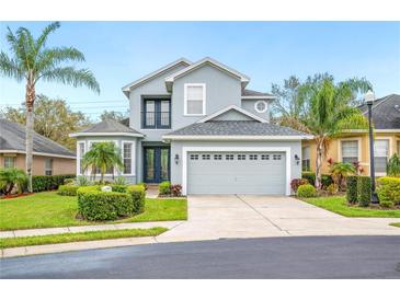 Charming two-story home features a well-manicured lawn, a two-car garage, and a welcoming front porch at 1108 Stoney Creek Blvd, Lakeland, FL 33811