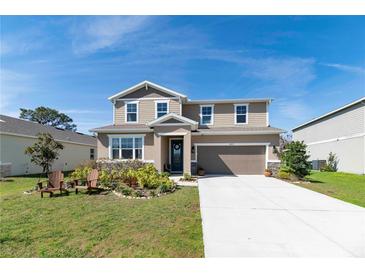 Charming two-story home boasts a well-manicured lawn and inviting curb appeal with a two car garage at 4525 Breccia Ln, Lakeland, FL 33811