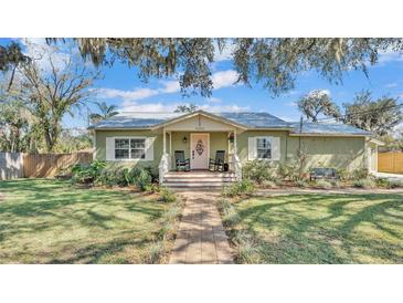 Charming home featuring a brick walkway, covered porch, and well-maintained lawn at 4620 S Gary Ave, Lakeland, FL 33813