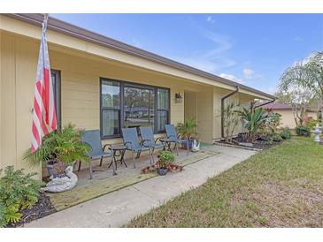 Charming front porch with seating and decorative plants and a US flag at 531 Gibson S Rd, Lakeland, FL 33813