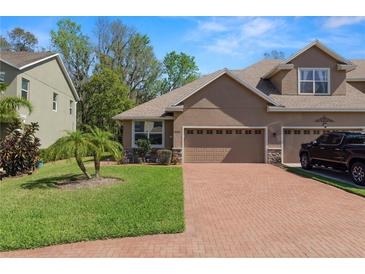 Charming home featuring a brick driveway, two-car garage, and well-maintained lawn at 6329 Torrington Cir, Lakeland, FL 33811