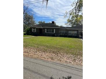 Charming single-story home with a spacious front yard and mature trees at 1197 De La Palma Ave, Bartow, FL 33830