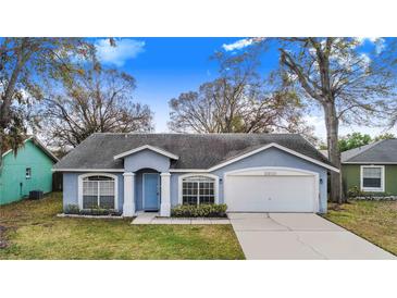Charming single-story home featuring a well-manicured lawn and attached two-car garage at 2613 Sundance Cir, Mulberry, FL 33860