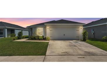 Charming single-story home featuring a well-manicured lawn and an attached two-car garage at 4424 Reding Way, Lakeland, FL 33813