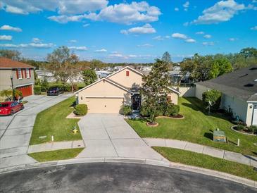 Charming single-story home featuring a well-manicured lawn and attached two car garage at 474 Cedar Glen Dr, Lake Alfred, FL 33850