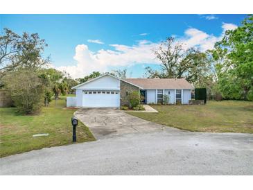 Charming single-Gathering home with a well-manicured lawn and attached two-car garage at 6305 Tocobega Dr, Lakeland, FL 33813