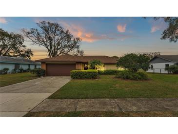 Charming single-story home with a well-maintained lawn, mature landscaping, and a cozy, inviting curb appeal at 7639 Lewis Rd, Lakeland, FL 33810