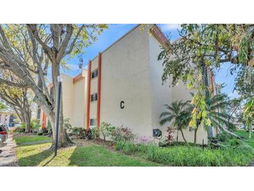 Well-maintained exterior of a multi-story residential building, surrounded by mature trees and landscaping at 1130 N Lake Parker Ave # C328, Lakeland, FL 33805