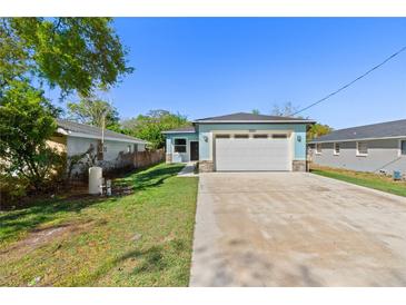 Charming single-Gathering home features an attached two-car garage and a well-maintained lawn at 127 Florida Dr, Winter Haven, FL 33881