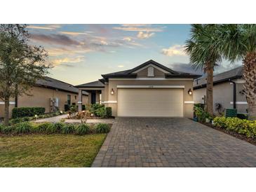 Charming single-story home with a well-manicured lawn, paver driveway, and a two-car garage at 1298 Zeek Ridge St, Clermont, FL 34715