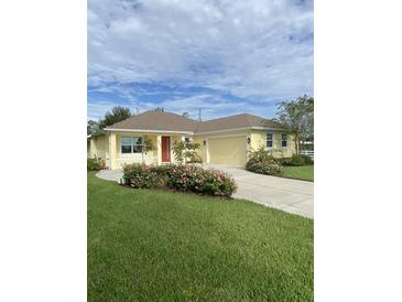 Charming one-story home with a manicured lawn, flowering shrubs, and a welcoming red front door at 3533 Britt Rd, Mount Dora, FL 32757