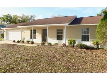 Charming single story home with a covered front porch, manicured landscaping, and a freshly painted exterior at 3626 Amber Ln, Lakeland, FL 33812