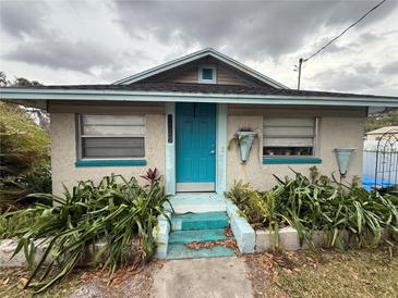 Charming home featuring a bright blue front door and vibrant landscaping at 5636 Old Highway 37, Lakeland, FL 33811