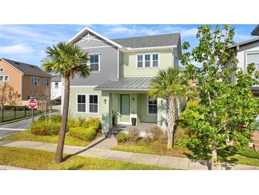 Charming two-story home with a well-maintained lawn and lush landscaping, including palm trees at 13119 Granger Ave, Orlando, FL 32827