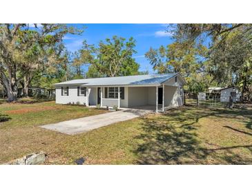 Charming single-story home with metal roof, covered carport, and well-maintained landscaping at 3035 Linda Dr, Lakeland, FL 33810