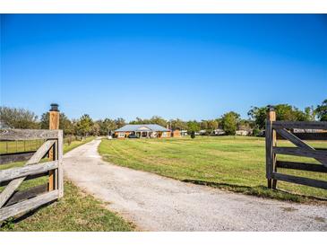 Gated driveway leads to charming ranch-style home with large front yard at 408 Old Bartow Lake Wales Rd, Bartow, FL 33830