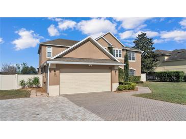 Charming two-story home featuring a neatly paved driveway and attached two-car garage at 4512 Brookshire Pl, Lake Wales, FL 33898