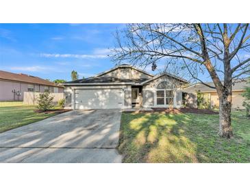 Charming single-story home featuring a well-manicured lawn and a two-car garage at 5207 St Lucia Dr, Lakeland, FL 33812