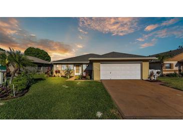 Charming single-story home featuring a well-manicured lawn and a two-car garage at 6211 Crane Dr, Lakeland, FL 33809