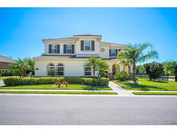 Charming two-story home with manicured landscaping and a paver walkway, blending elegance with curb appeal at 6515 Eagle View Loop, Lakeland, FL 33813