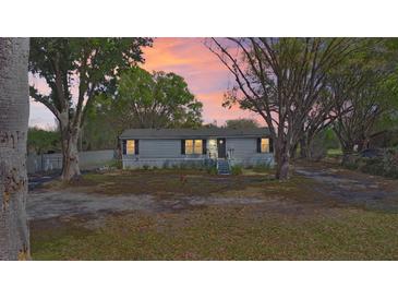 Charming single story home with beautiful sunset, mature trees, and inviting front porch at 6525 Glen Meadow Dr, Lakeland, FL 33810