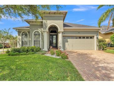 Charming single-story home featuring a well-manicured lawn and a welcoming arched entryway at 914 Christina Chase Dr # Drive, Lakeland, FL 33813