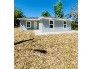 Charming single-story home with a well-maintained lawn and neutral gray exterior at 1522 Kettles Ave, Lakeland, FL 33805