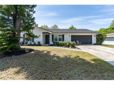 Charming single-story home featuring a well-maintained front yard and a two-car garage at 221 Stevenson Rd, Winter Haven, FL 33884