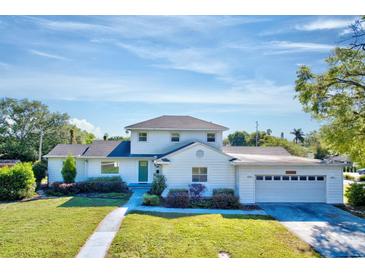 Charming two-story home with a well-maintained lawn, beautiful landscaping, and attached two-car garage at 2816 Fairmount Ave, Lakeland, FL 33803