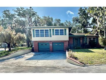 Charming two-story home with a well-maintained front yard and a two-car garage at 302 Luna Rd, Auburndale, FL 33823