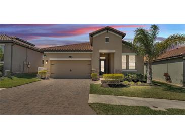 Charming single-Gathering home with a two-car garage, manicured lawn, and colorful landscaping at 4232 Prima Lago Dr, Lakeland, FL 33810