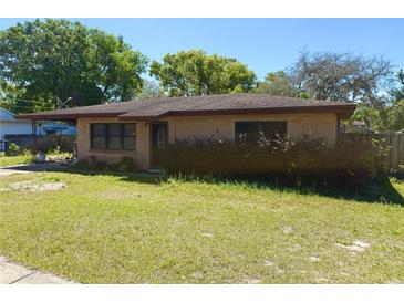 Charming single story brick home with a well-maintained lawn and mature landscaping at 460 W Pierce St, Lake Alfred, FL 33850