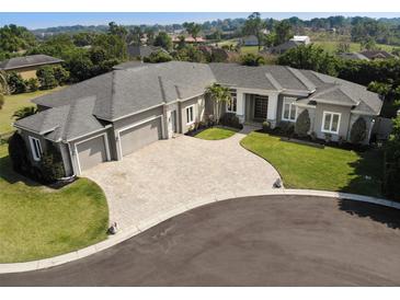 Stunning single-story home featuring a circular driveway and a three-car garage at 6470 Ashley Dr, Lakeland, FL 33813